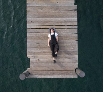 Gelukkige vrouw ligt op een stijger en heeft een goede mental health door de instagram accounts die ze volgt.